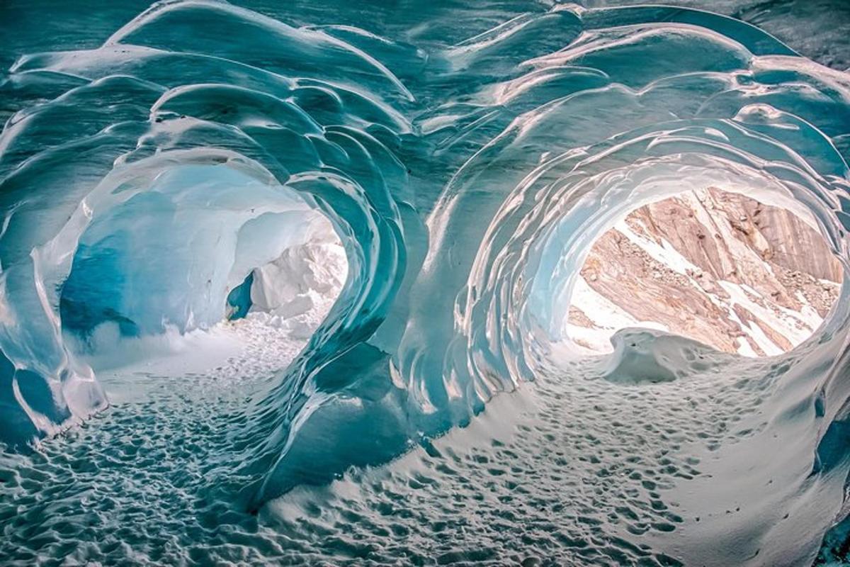 an ice cave in a glacier with snow