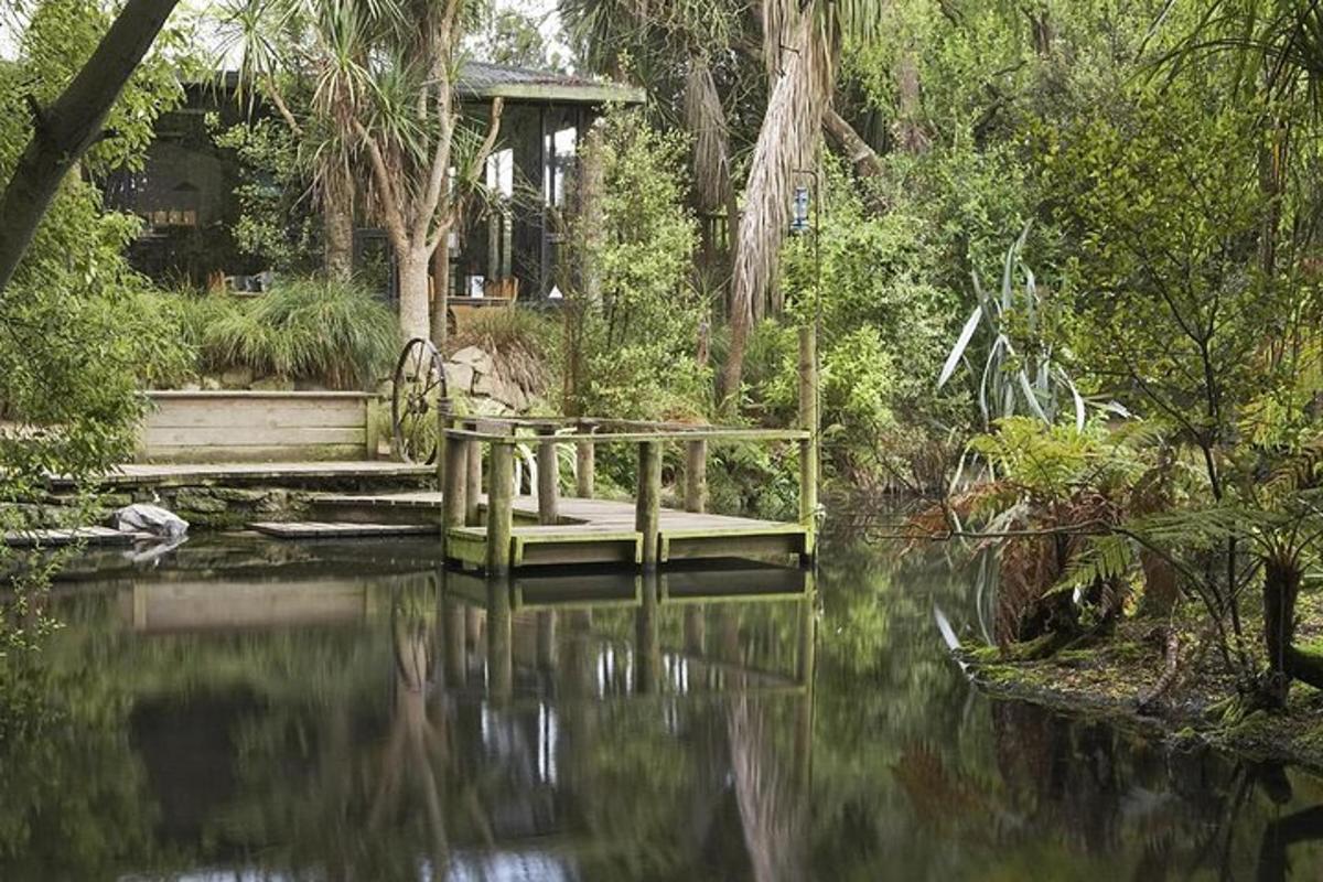 a wooden bridge over a pond in a garden