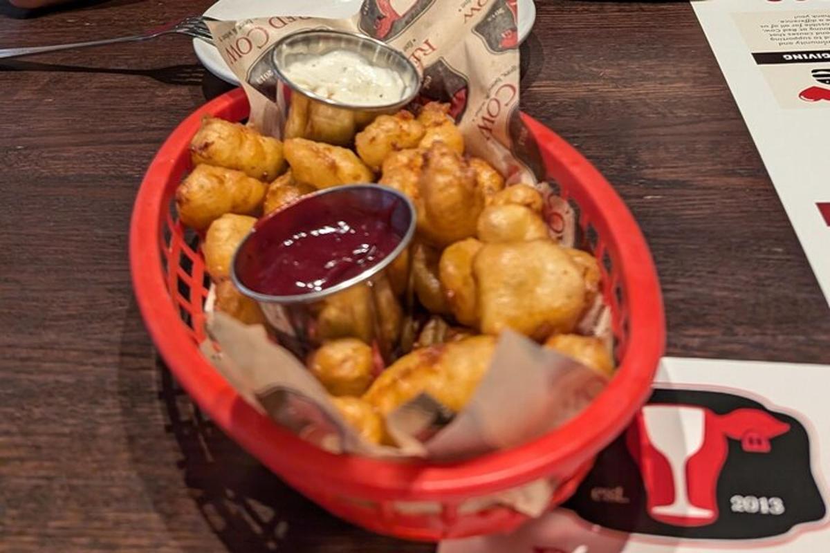 a red basket filled with food on top of a table