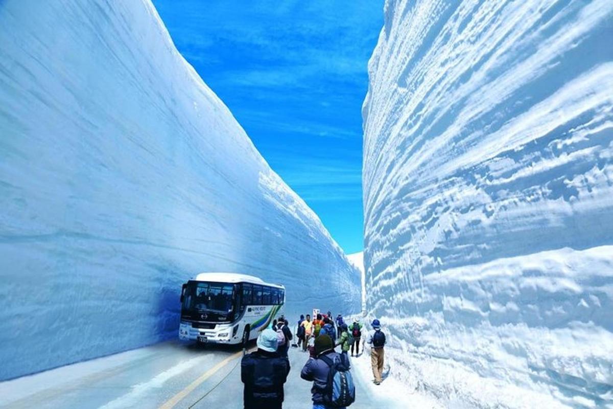 a group of people walking in front of a bus