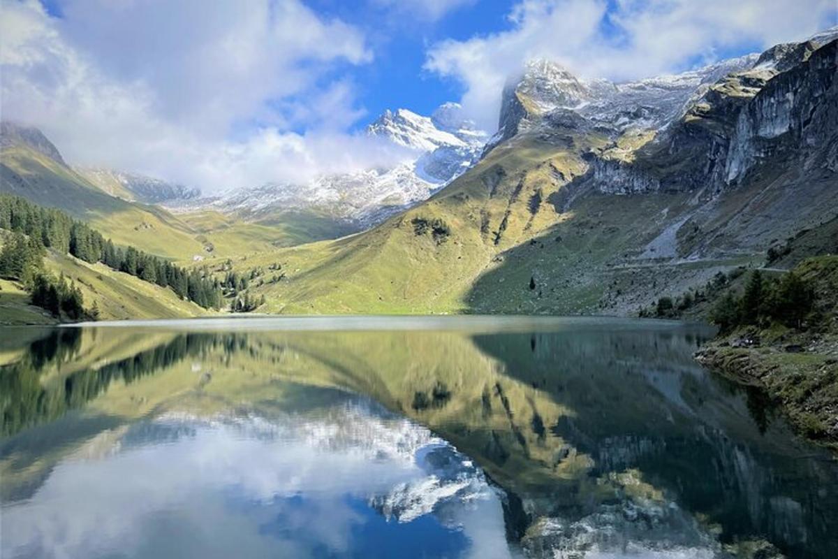 a reflection of a mountain in a body of water