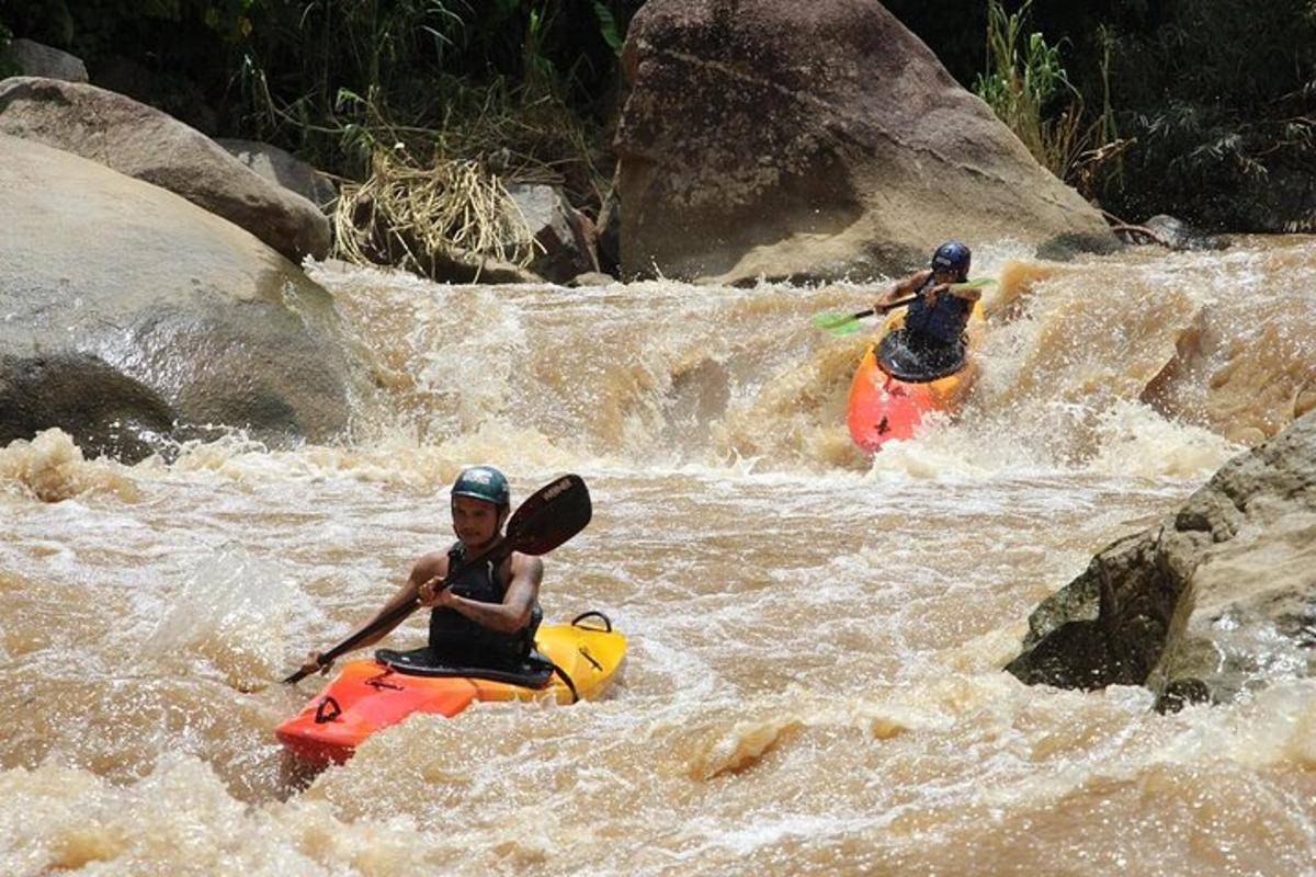 two people on kayaks in rapids on a river