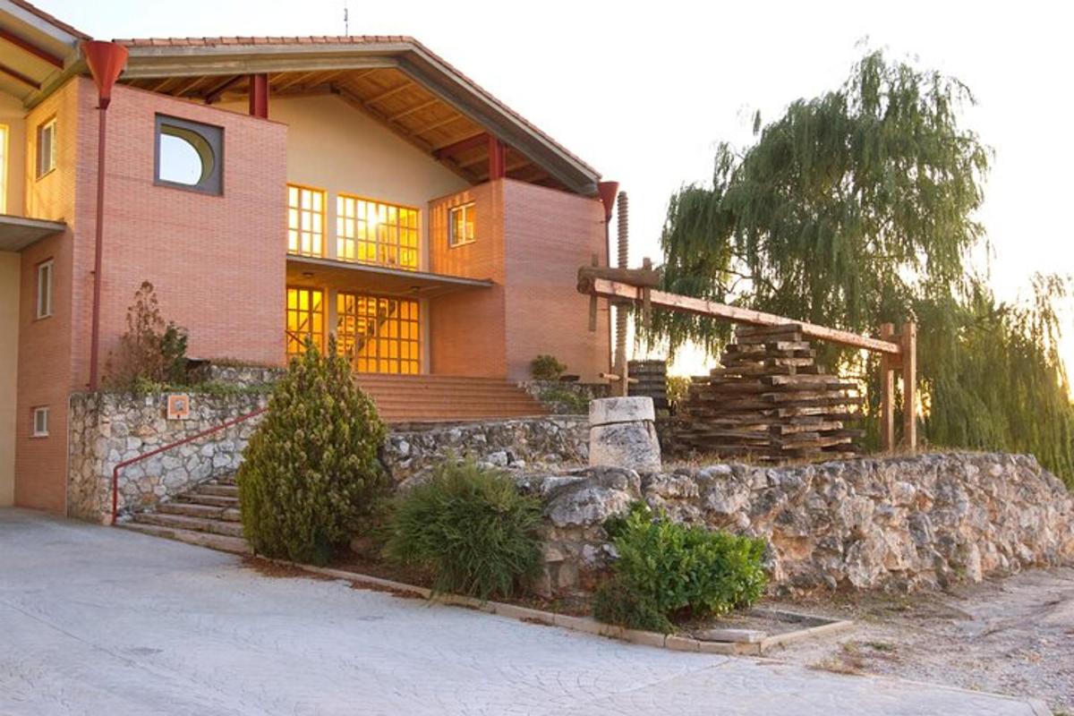 a house with a stone retaining wall and a stone staircase