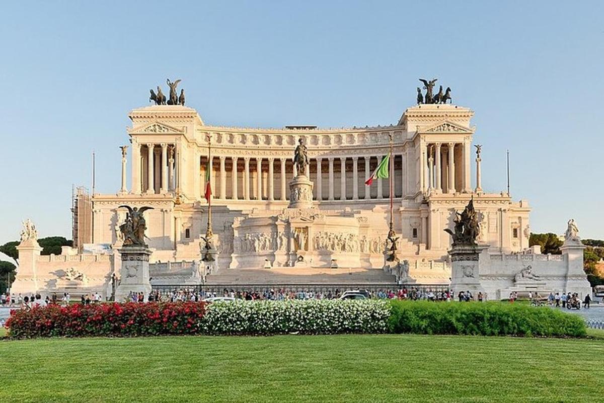a large building with a green field in front of it