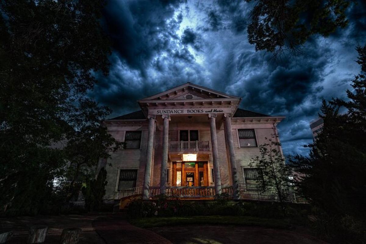 a building at night with a cloudy sky