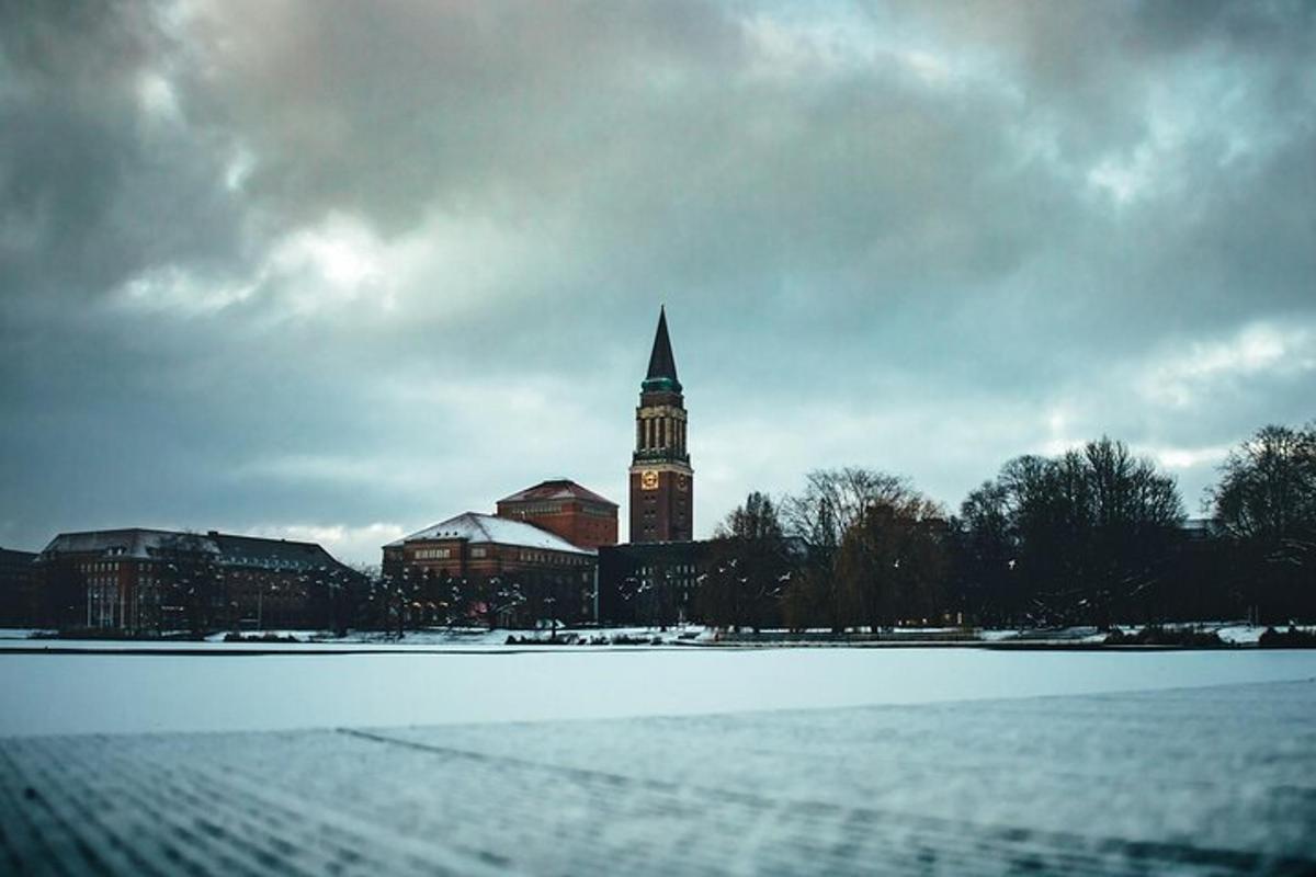 a building with a clock tower with a snow covered field