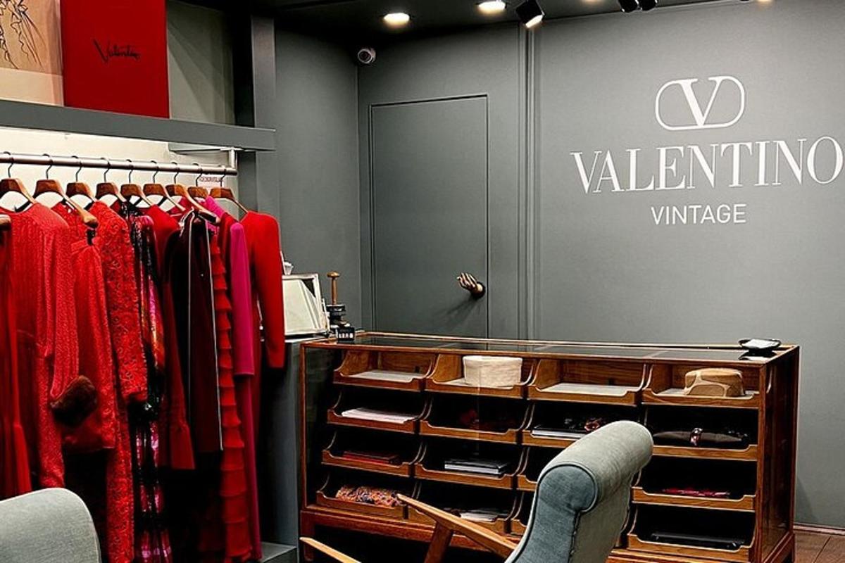 a clothing store with red clothes on racks