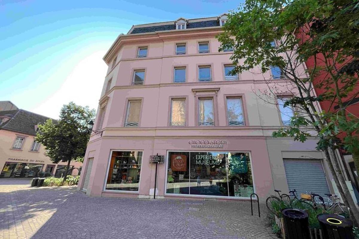 a pink building with a store in front of it
