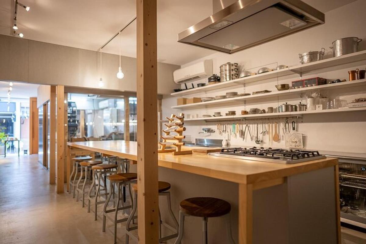 a kitchen with a long counter and a long bar with stools