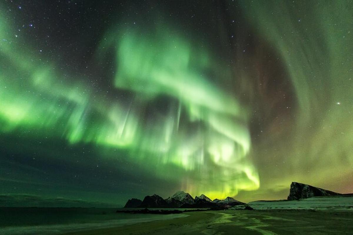 an aurora in the sky over a field