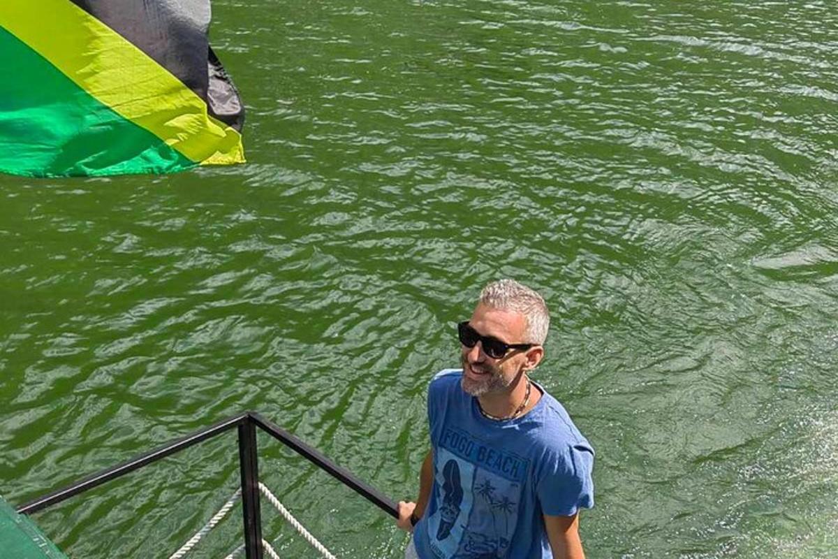 a man standing on a boat in the water