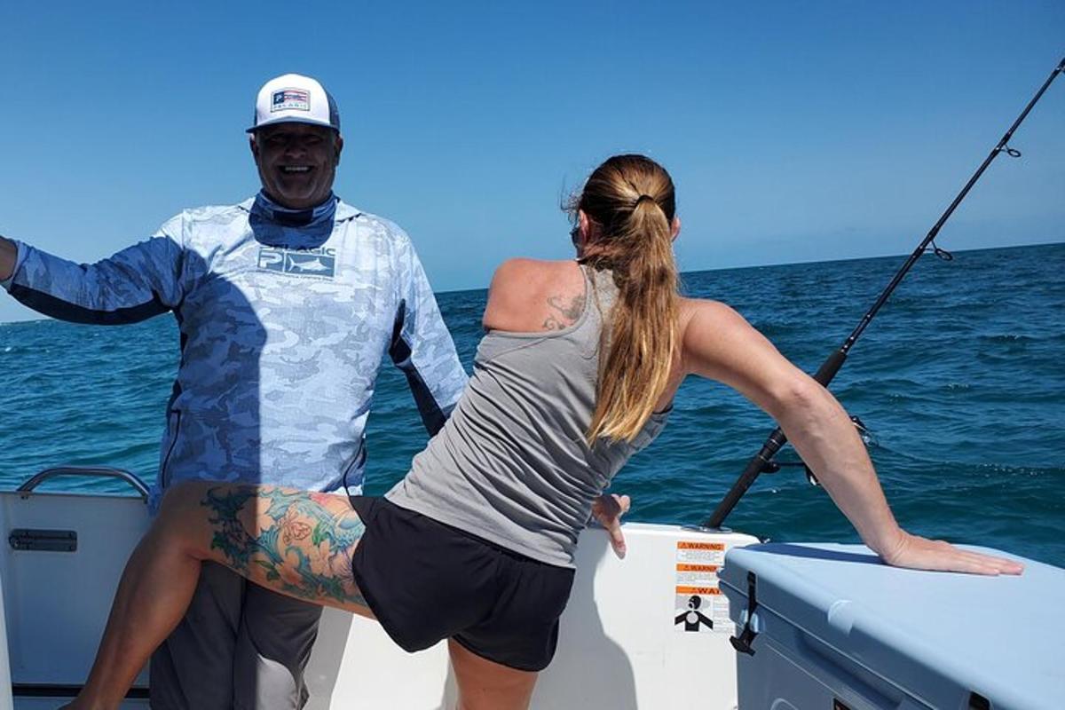 a man and a woman on a boat in the water