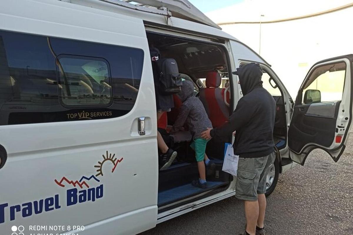 a group of people getting out of a travel band van