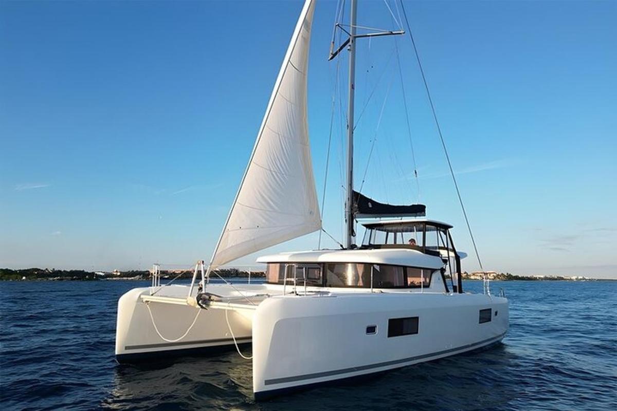 a white sail boat sitting in the water