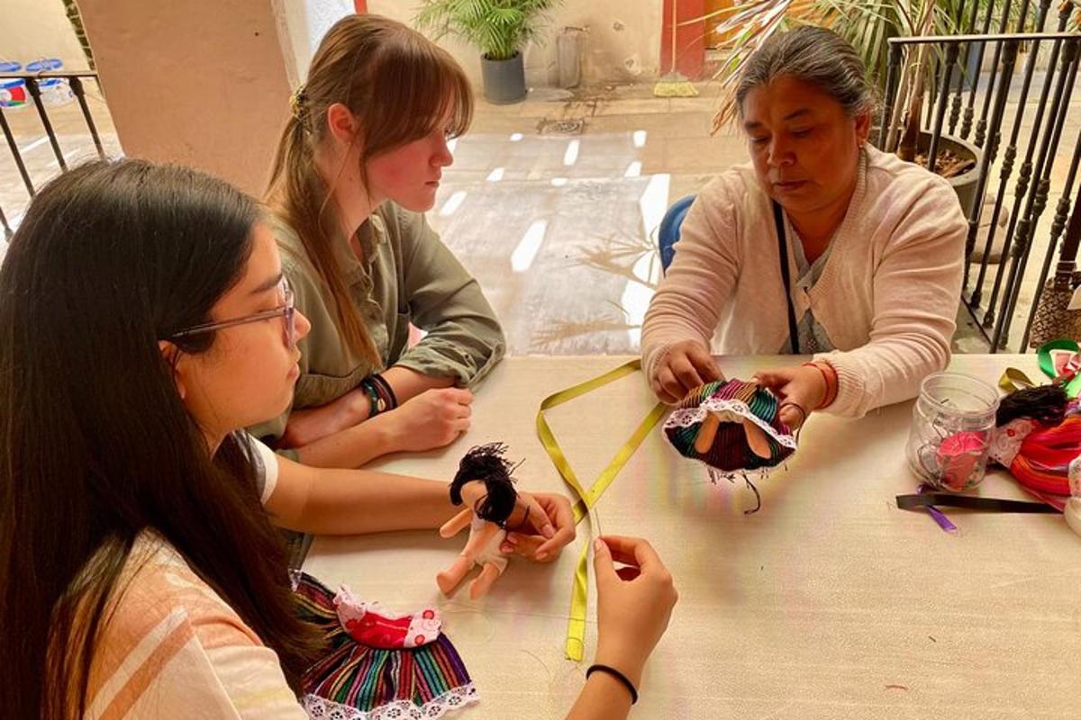 three women sitting at a table playing with a toy