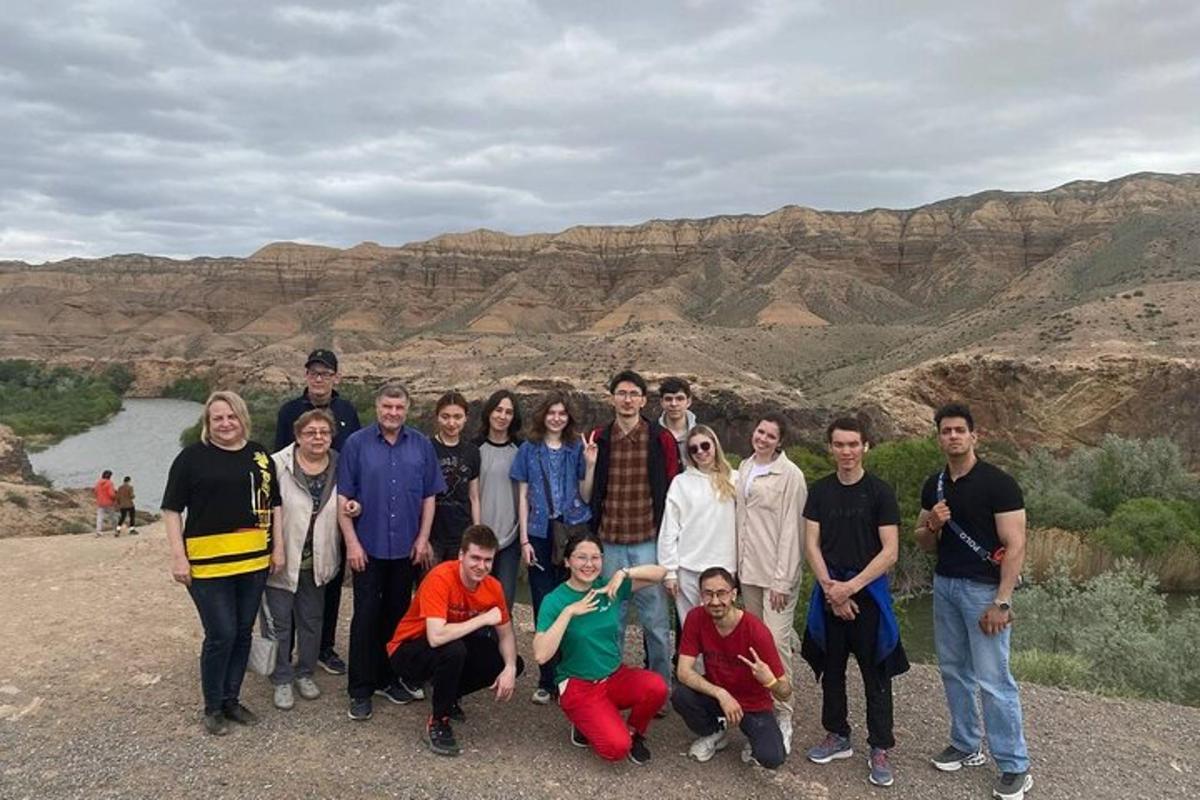 a group of people posing for a picture in the desert