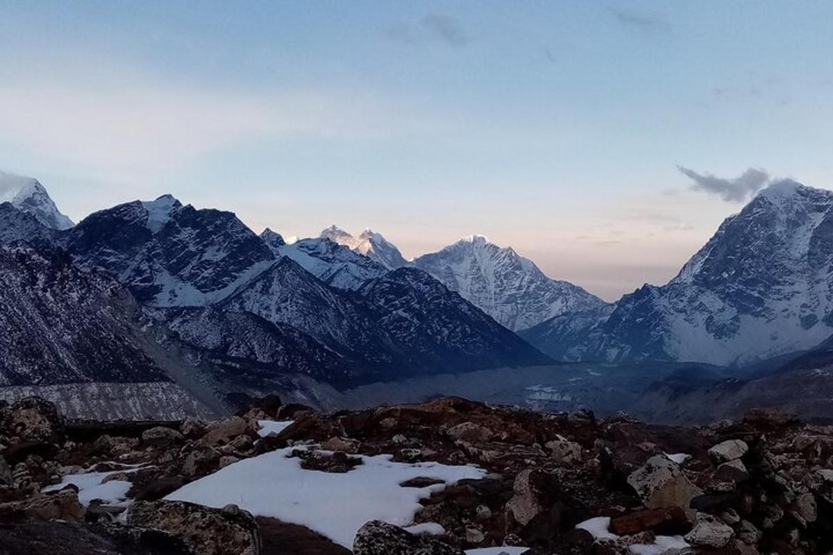 a mountain range with snow covered mountains in the distance