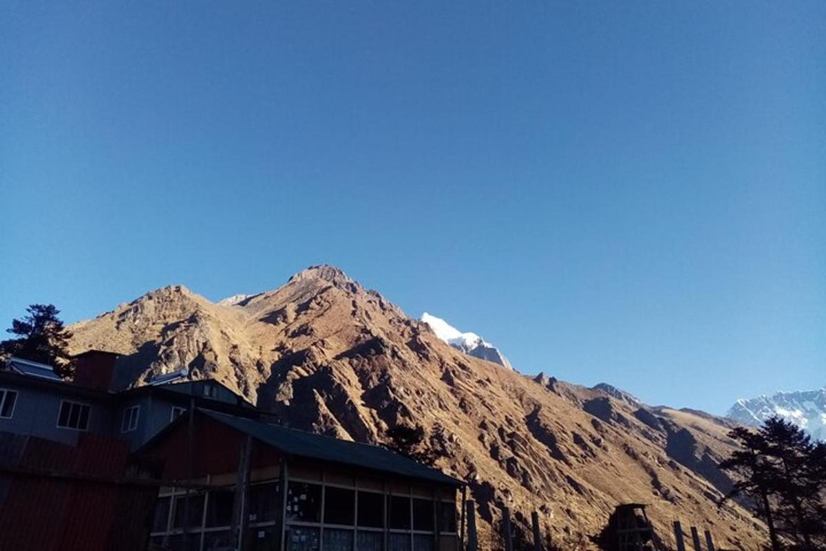 a building in front of a mountain with snow