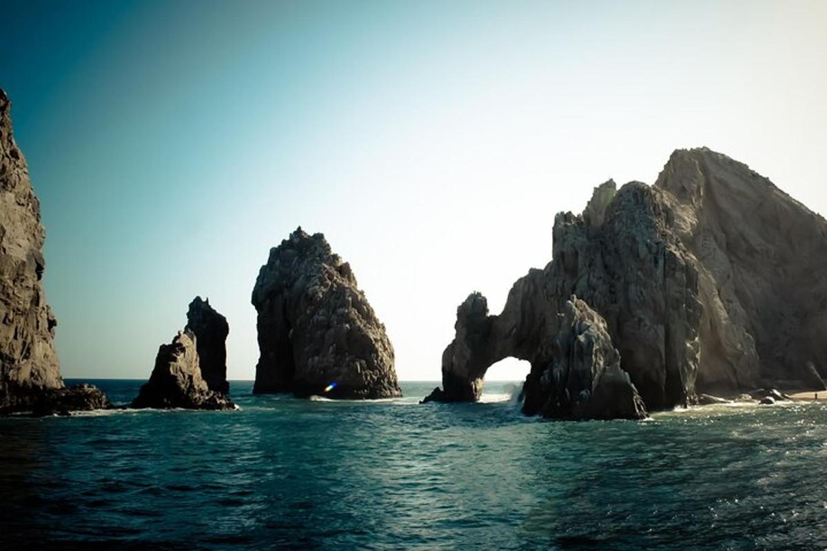 a group of rocks in the water near the ocean