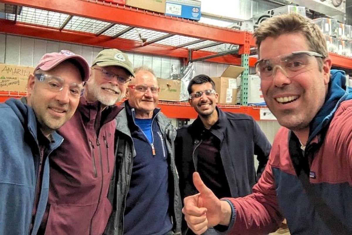 a group of men posing for a picture in a store