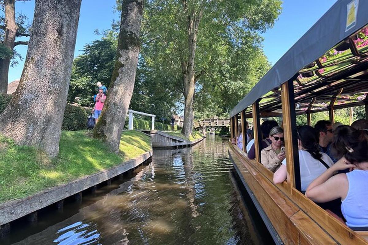 a group of people riding on a boat in a canal