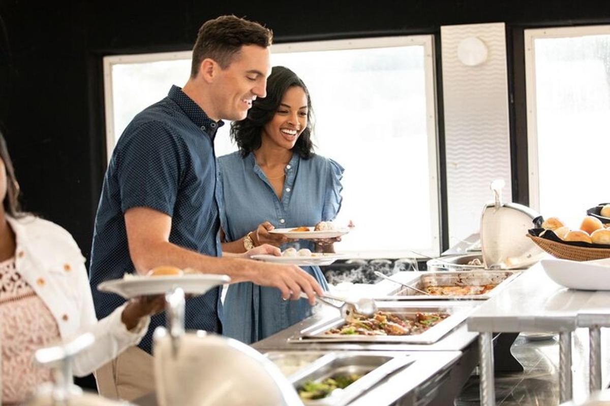 a man and woman standing in a kitchen preparing food