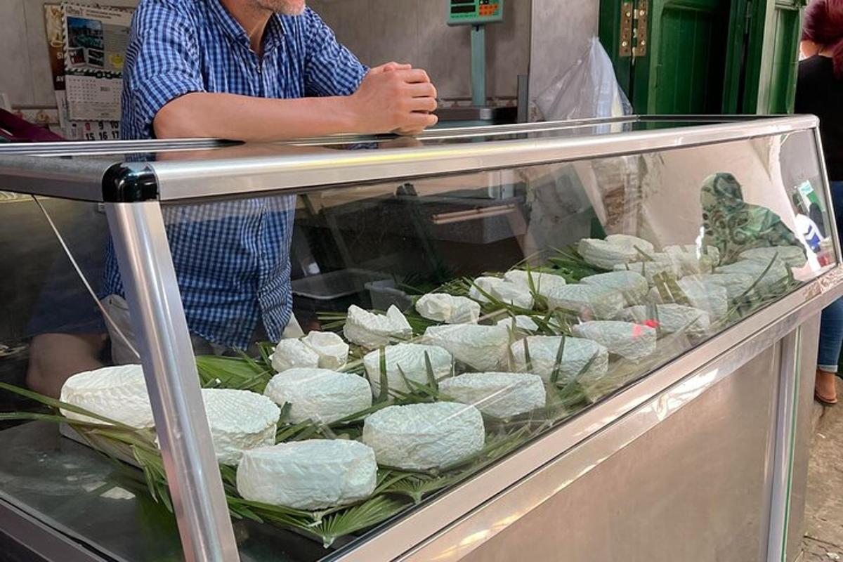 a man is preparing food in a display case