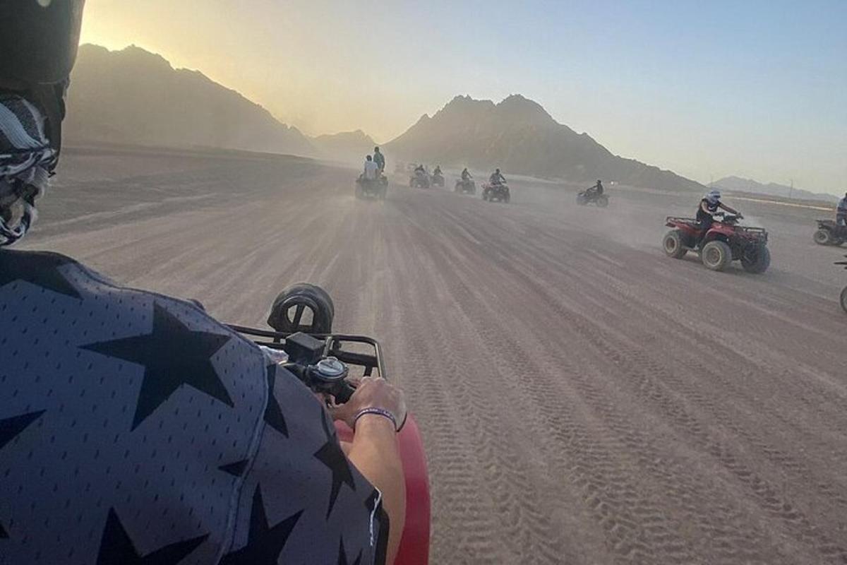 a group of people riding motorcycles on a dirt road