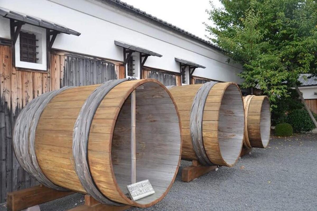 a row of wooden barrels sitting next to a building