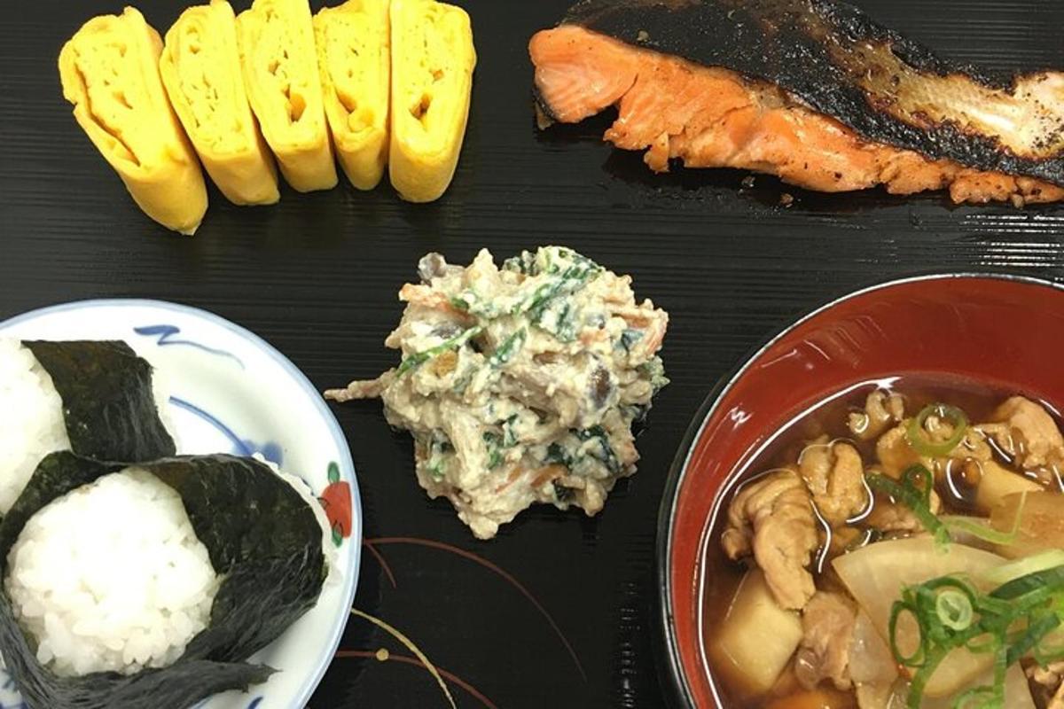 a table with a plate of food and a bowl of rice