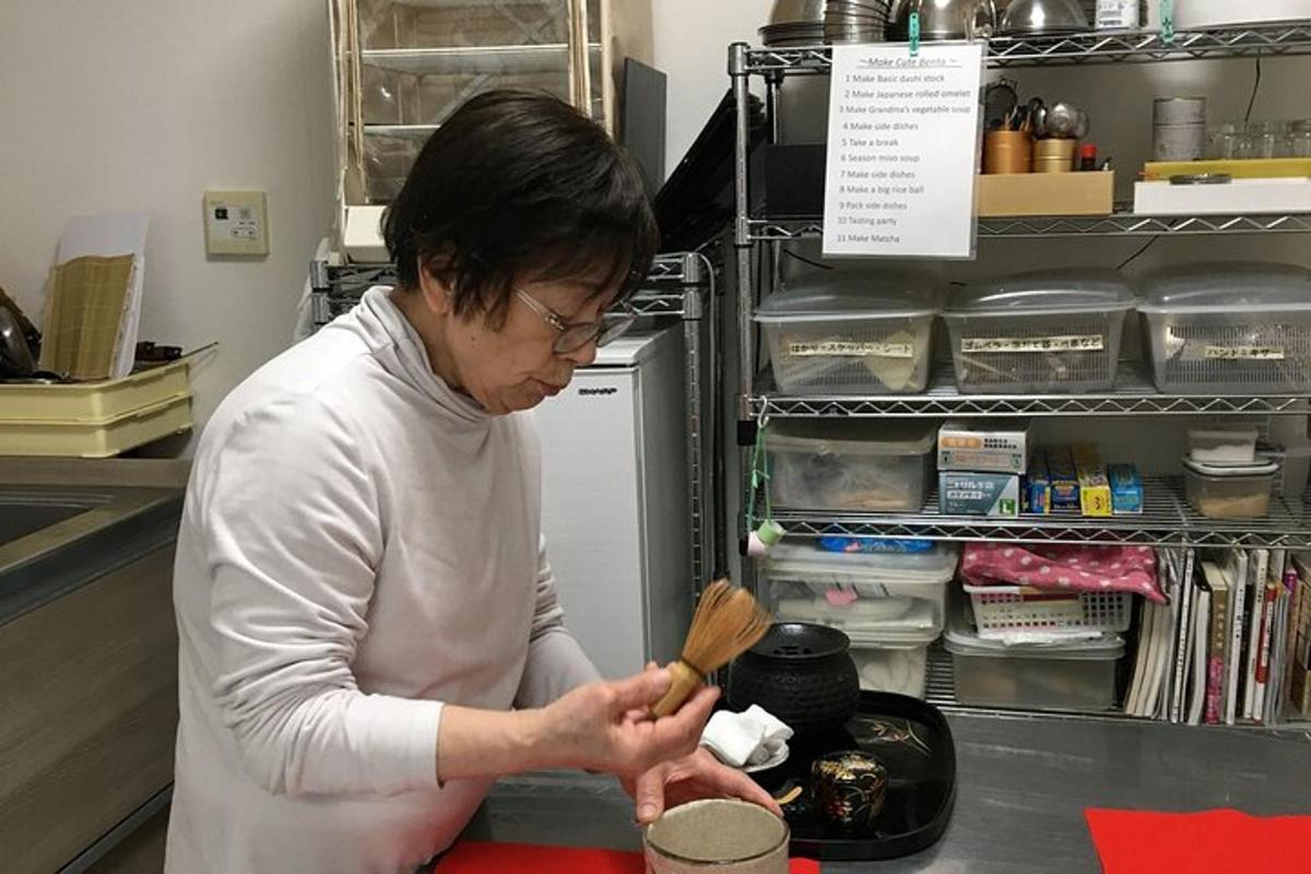 a woman standing in a kitchen preparing food