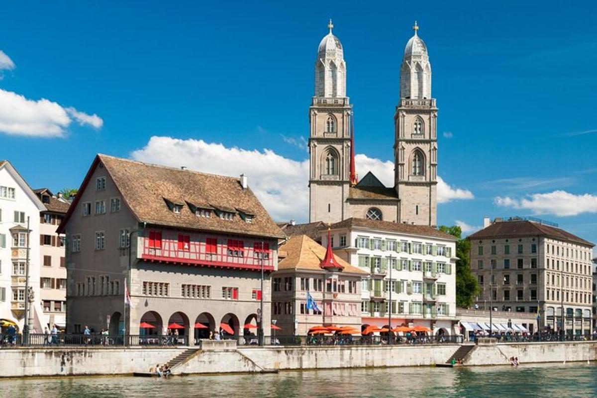 a group of buildings with a church and a river
