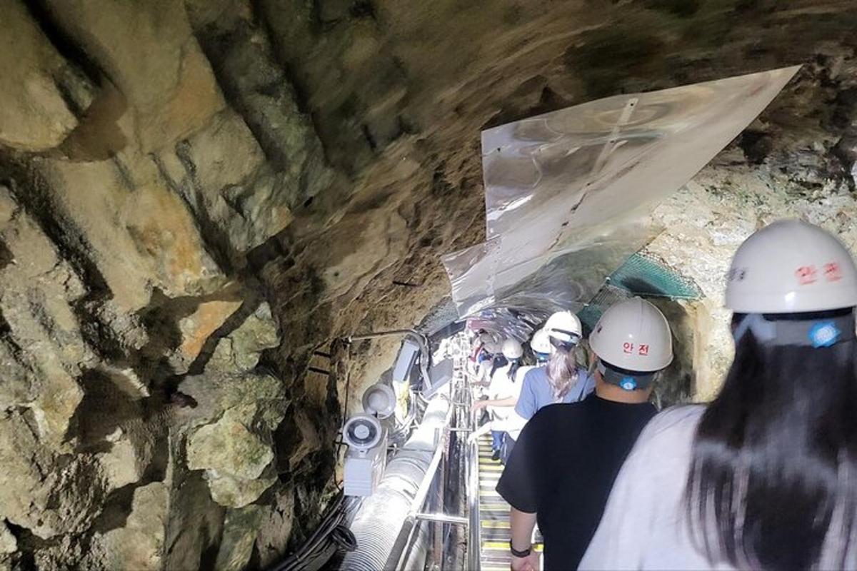 a group of people wearing hard hats in a tunnel