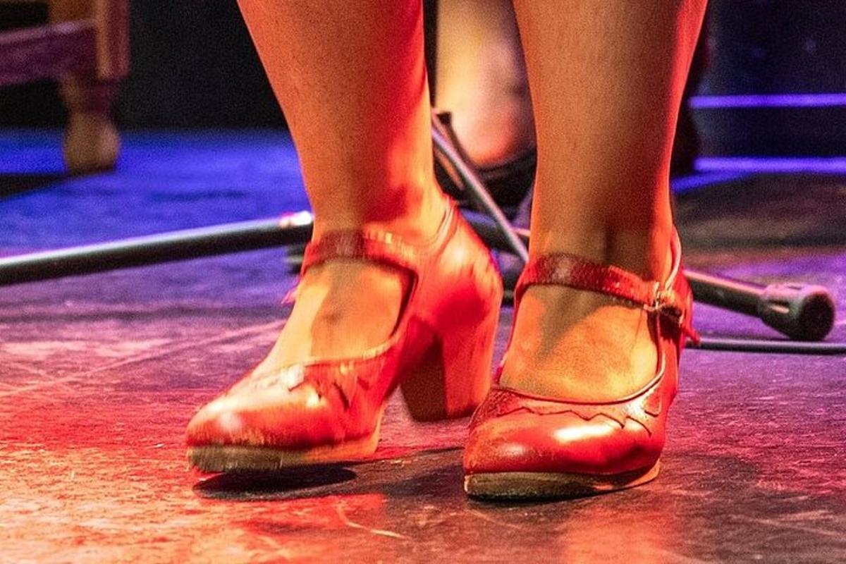 a woman in red heels standing on a stage