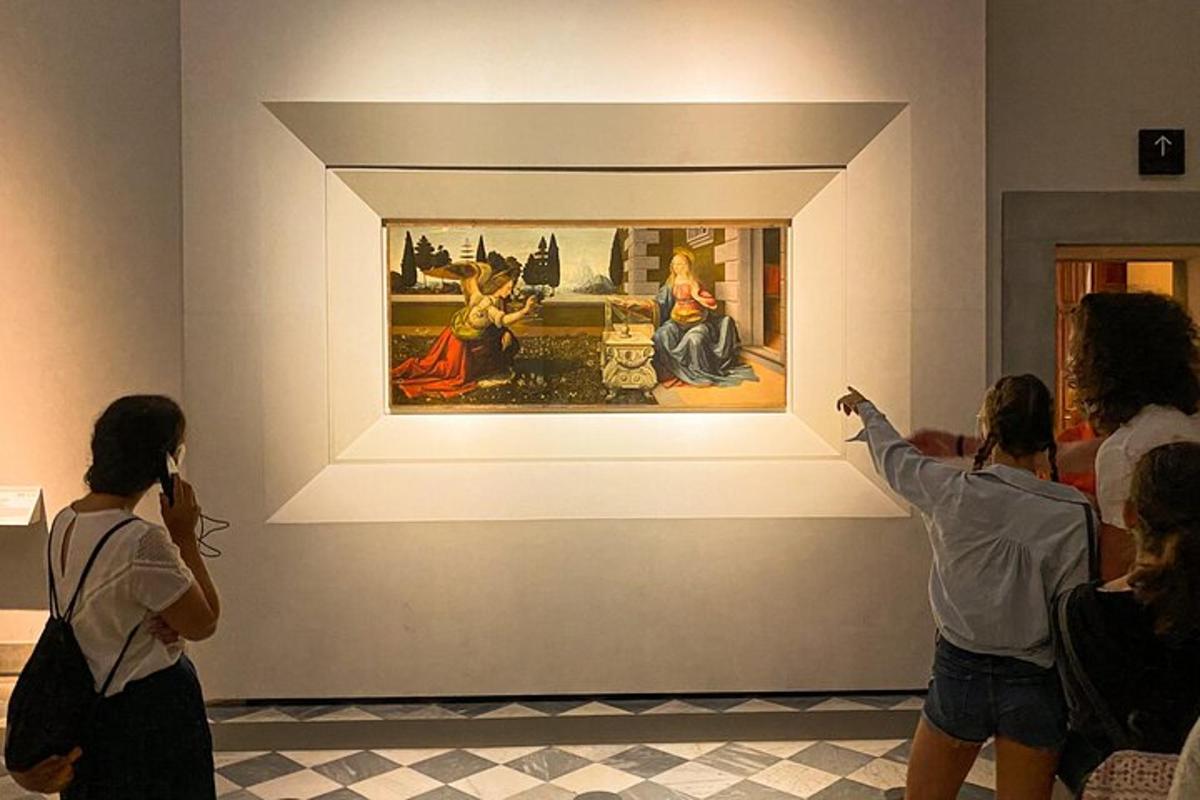 people taking pictures of a painting in a museum