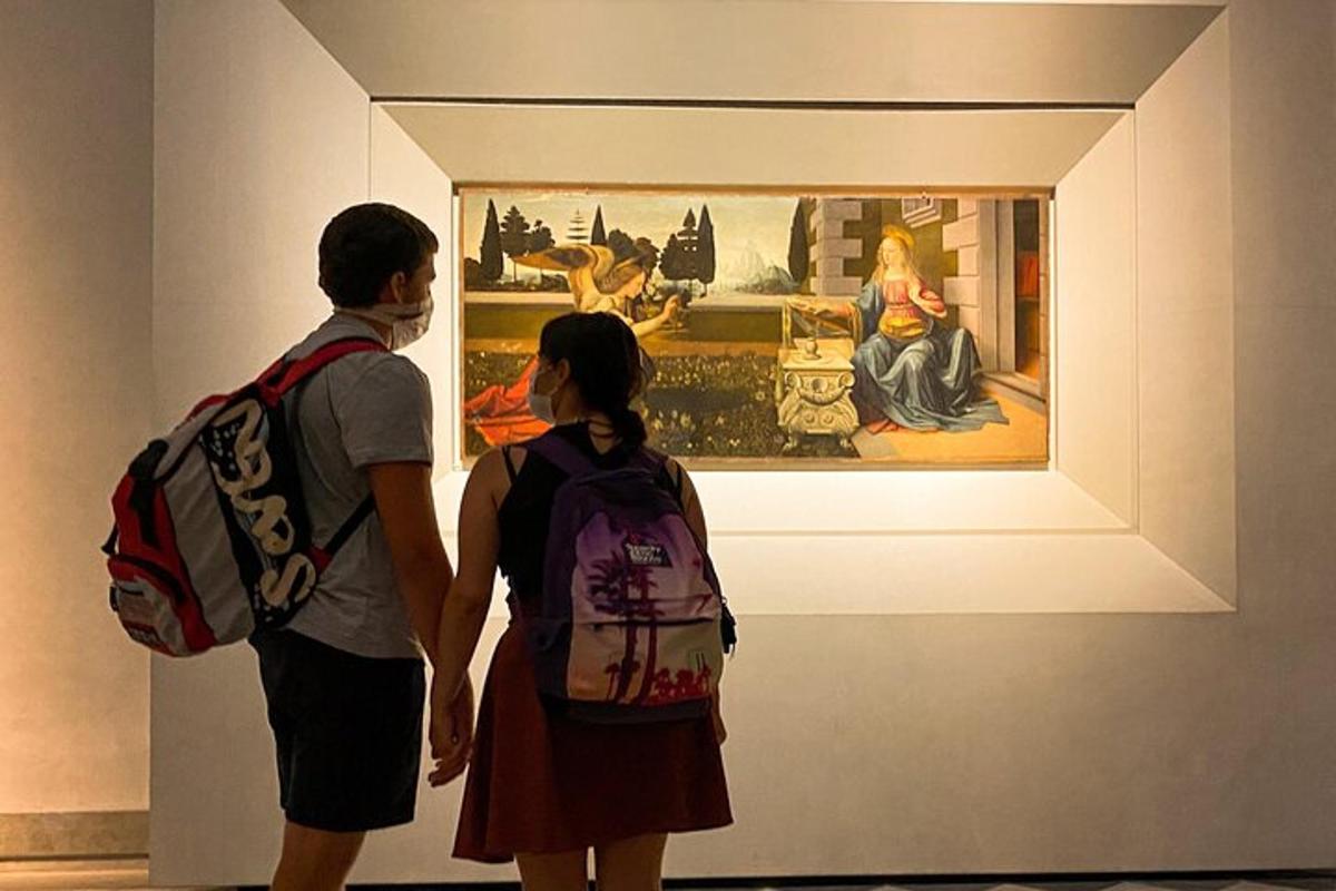 a man and woman looking at a painting in a museum