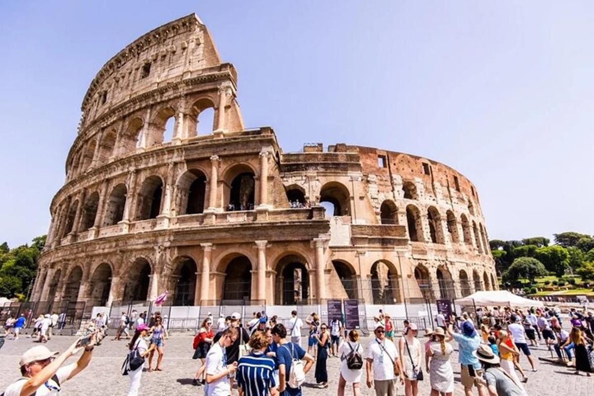 a group of people standing in front of the coliseum