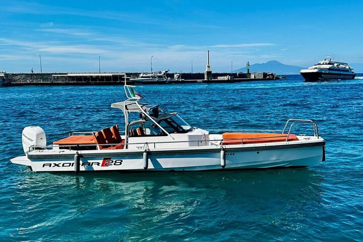 a white boat in the water with a cruise ship