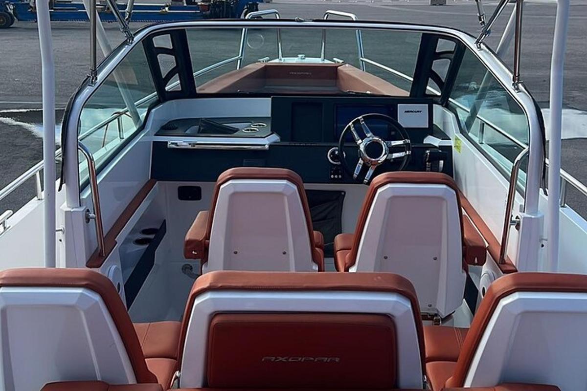 a boat with chairs and a steering wheel on it