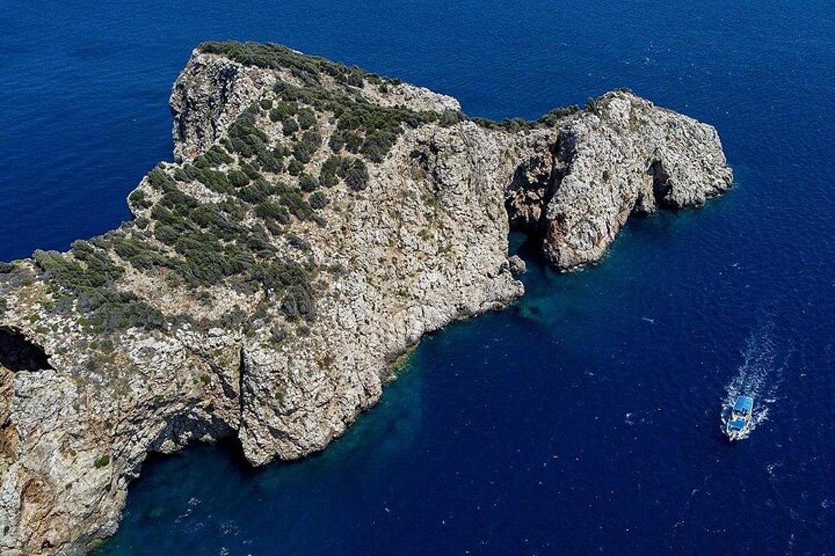 an island in the ocean with a boat in the water