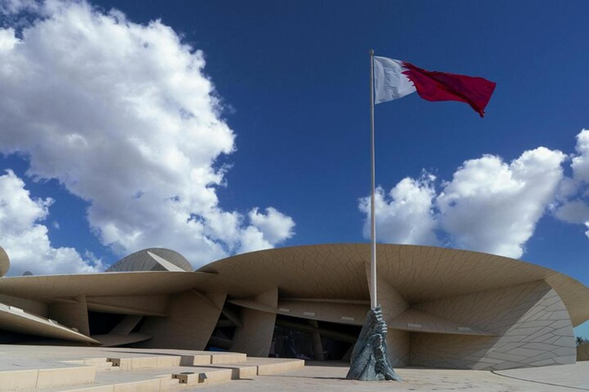 a red and white flag in front of a building