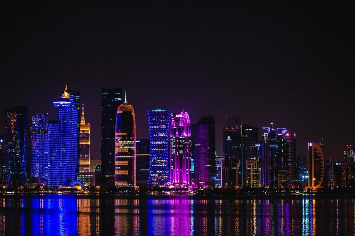 a city skyline at night with purple and violet lights