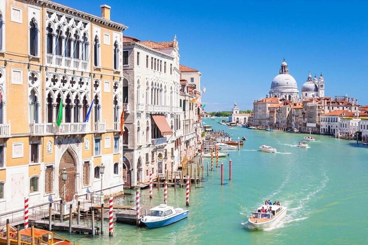 a group of boats on a river between buildings