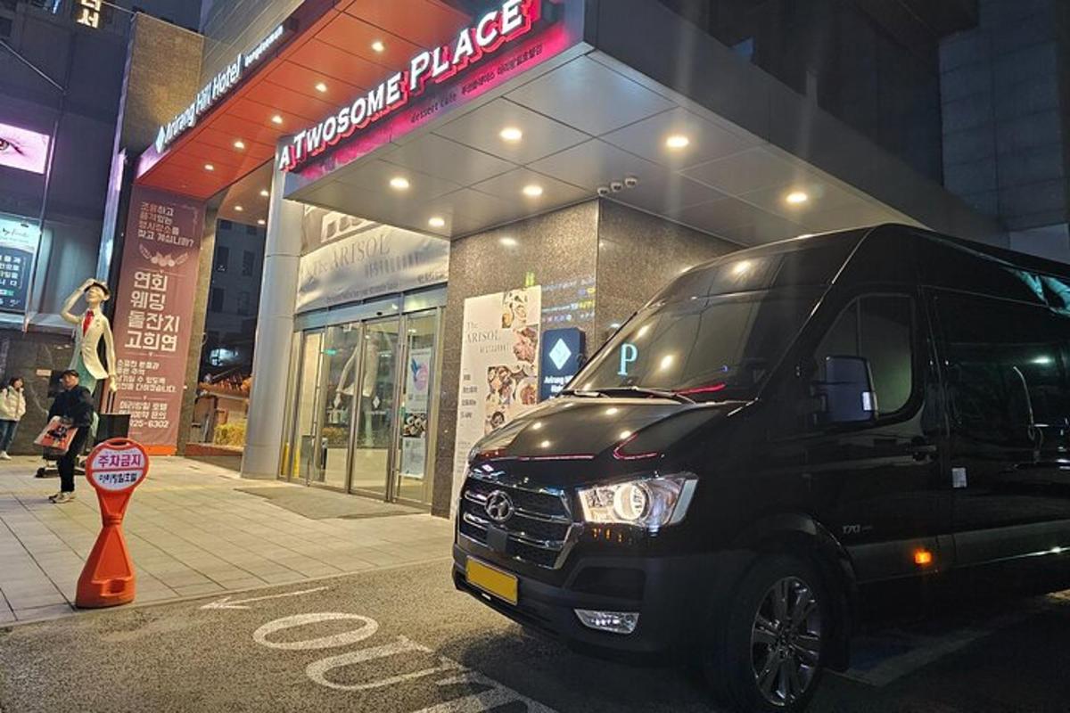 sebuah mobil van hitam terparkir di depan sebuah toko