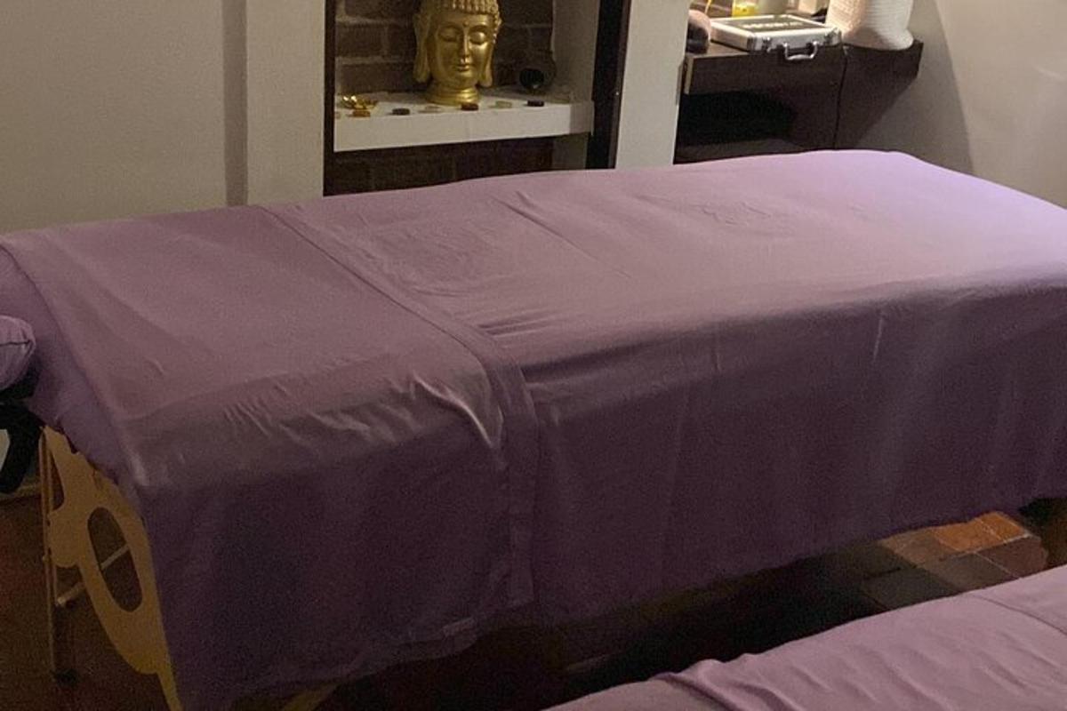 a bed with a purple blanket on top of it