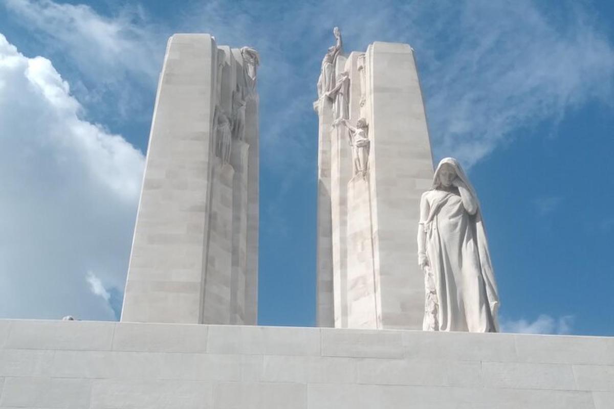 a statue of a woman standing on top of a monument