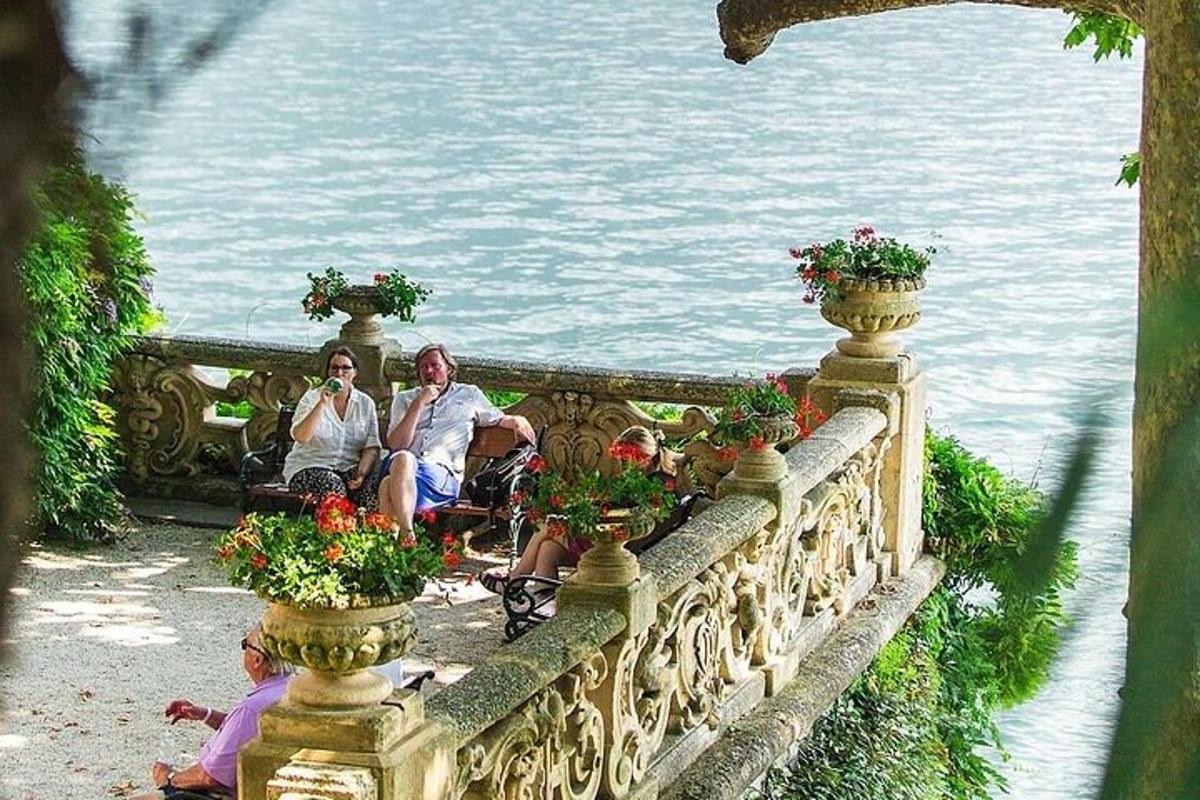 a group of people sitting on a bridge near the water