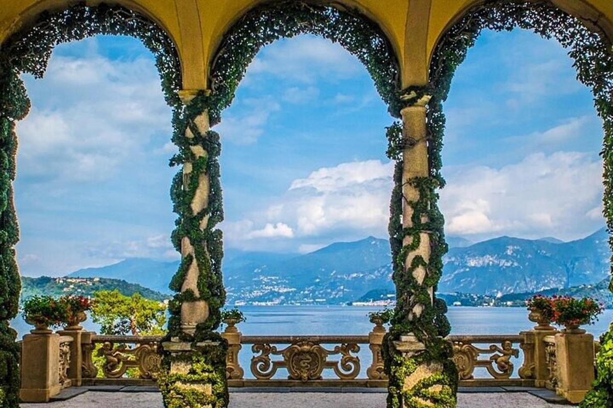 an archway with a view of the water and mountains