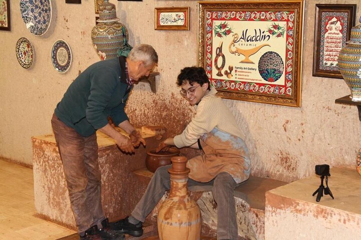 an older man and a woman making a vase