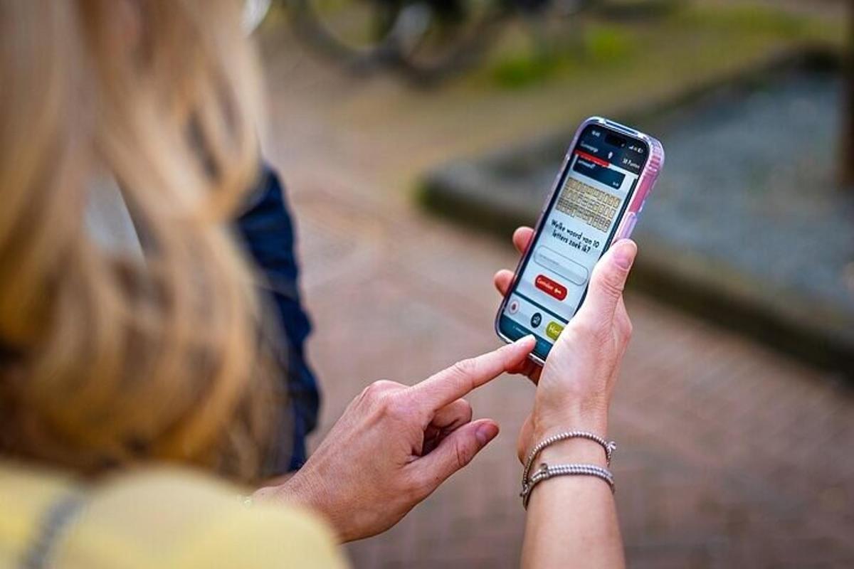 a woman is holding up a cell phone
